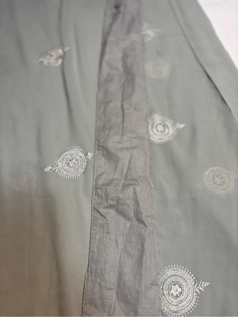 218” Legnth sage green draped saree features delicate silver embroidery